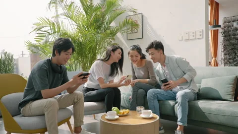 Young Chinese friends using smart phones on sofa,4K Stock Footage 206222139