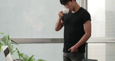 Young Chinese man drinking coffee at home,4K Stock Footage 156370241