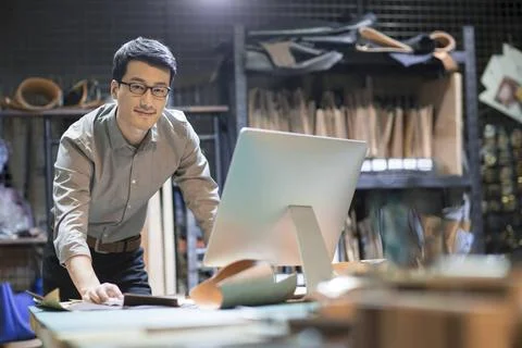  Young Chinese man using computer in studio Beijing China Copyright: xLian... Stock Photos