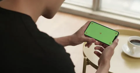 Young Chinese man using smartphone at home,4K Stock Footage 156365639
