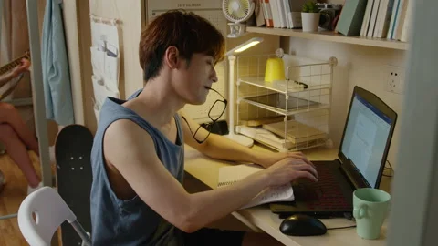 Young Chinese university student using laptop in dormitory,4K Stock Footage 211508455