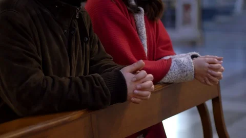 Young Christian couple praying together in church-profile Stock Footage