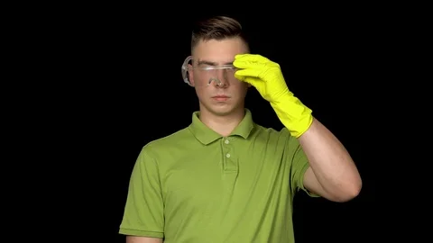 A young cleaner puts on glasses and holds a toilet brush in his hand. Man is Stock Footage 118853667