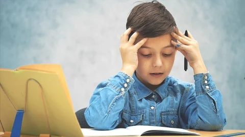 Young clever school kid in blue jeans t-shirt was writing and made a mistake Video stock 116623391