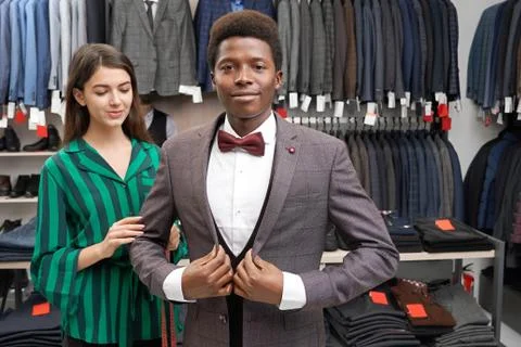 Young client fitting elegant suit, looking at camera. Stock Photos