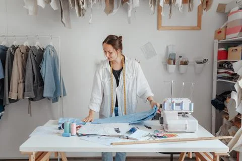 Young clothes designer in her studio. Fashion designers at work. tailor working Stock Photos
