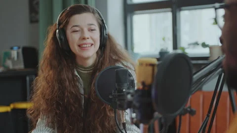 Young Co-Hosts Recording Audio Podcast Together in Studio Stock Footage 273766246
