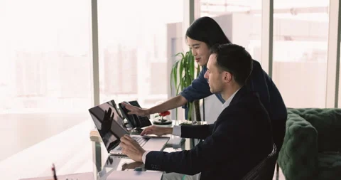 Young coach help with project to mature male colleague Stock Footage 281367336