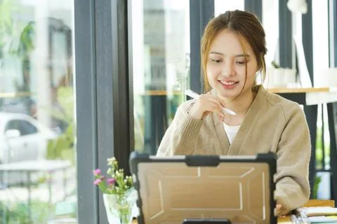Young collage student using computer and mobile device studying online.. Stock Illustration