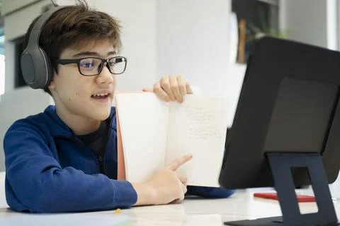 Young collage student using computer and mobile device studying Stock Photos