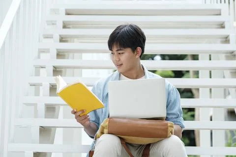 Young collage student using computer and mobile device studying Stock Photos