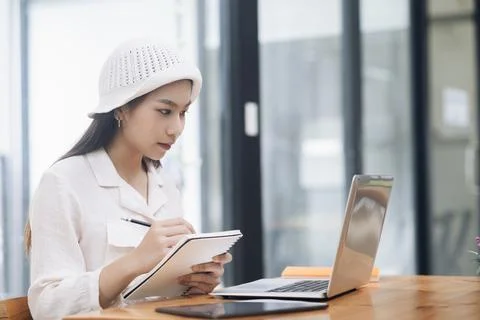 Young collage student using computer and mobile device studying Stock Photos