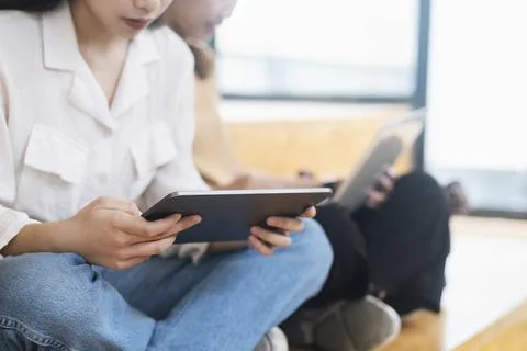 Young collage student using computer and mobile device studying Stock Photos