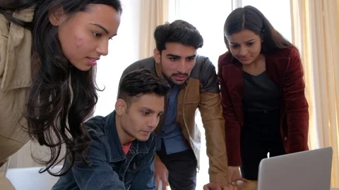 Young colleague explains things to his coworkers and they share high five, gimba Stock Footage 101185082