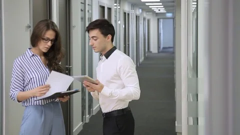 Young colleagues are talking standing in corridor of company. Stock Footage 81848237