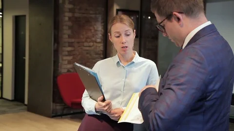 Young colleagues are talking while standing in large company. Stock Footage 83405898