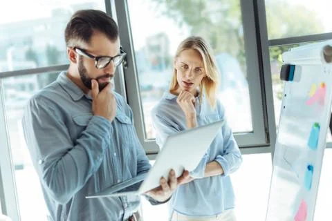 Young colleagues pondering over the problem solution Stock Photos