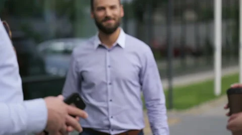 Young colleagues talking to each others in front of office Stock Footage 64107105