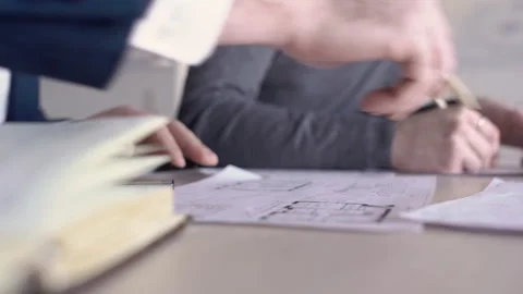 Young colleagues work while sitting at table in architect bureau. Stock Footage 85626235