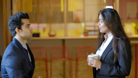 Young colleagues workers facing each other discussion work as they smile and hig Stock Footage 104896133