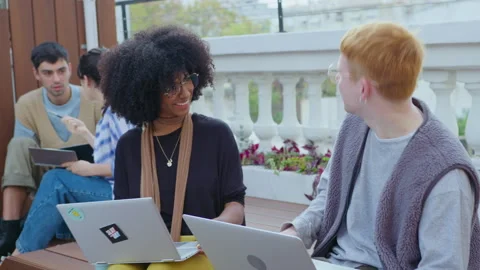 Young Colleagues Working with Laptops and Speaking Outdoors Stock-Footage 243950641
