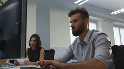 Young colleagues working in the office Stock Footage 68301038