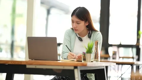 Young college student have question and answer to teacher by video call E Stock Footage 185359868