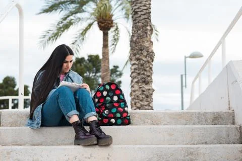 Young college student taking notes on campus outdoor Foto stock