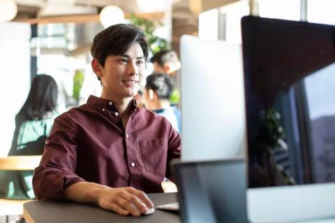 Young college student using computer 写真素材