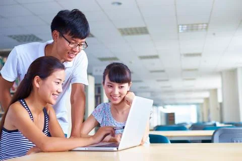 Young college students study together in the library Stock Photos