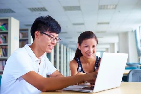 Young college students study together in the library Stock Photos