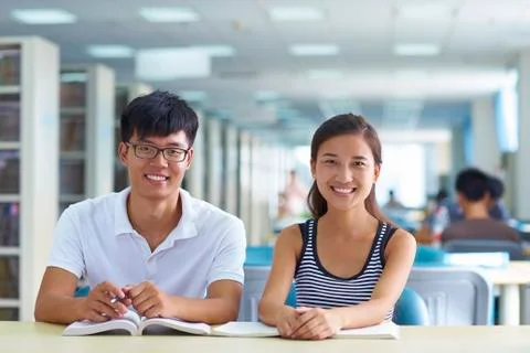 Young college students study together in the library Stock Photos