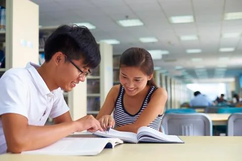 Young college students study together in the library Stock Photos