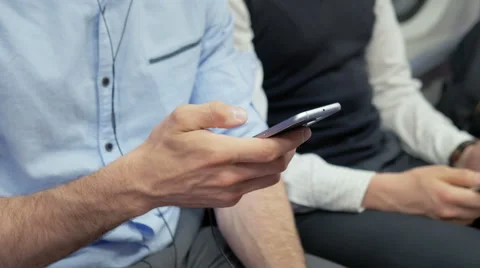 Young commuter using the phone while traveling on the subway train Stock Footage 67260484