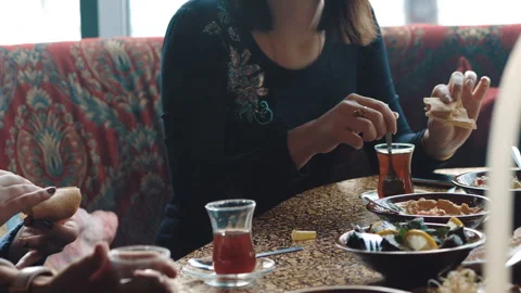 Young company is having fun and eating in bar. smoking a hookah, communicating Stock Footage 87188501