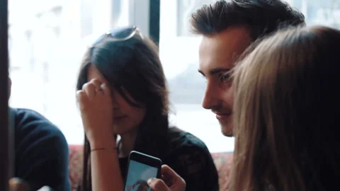 Young company is having fun and eating in bar. smoking a hookah, communicating Stock Footage 87189301