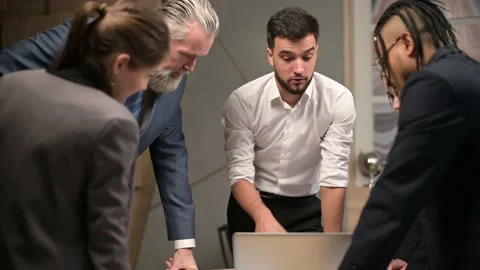 A young company manager proposes a solution to the problem at a meeting Stock Footage 144077128
