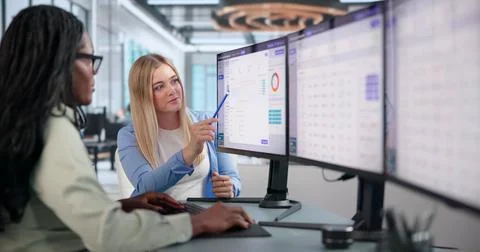 Young Compliance Officer Using Computer To Review Confidential Case Details. Stock Photos