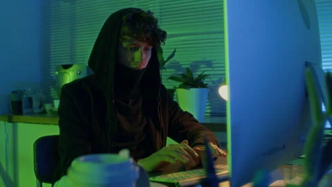 Young Computer Criminal in Black Clothes Accessing Confidential Information Stock Footage 299265673