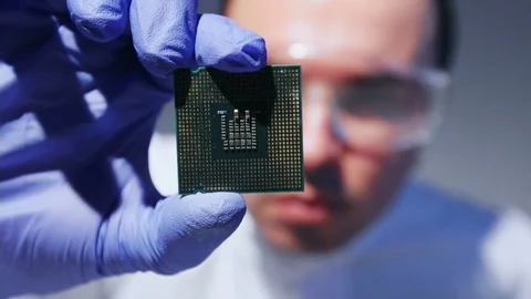 Young Computer Engineer is Holding and Inspecting Processor. 動画素材 84379725