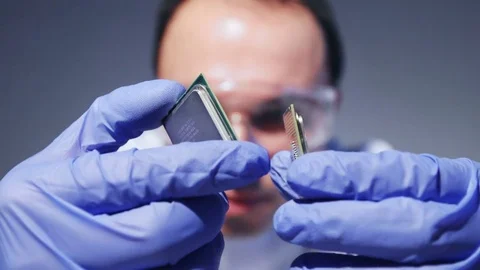 Young Computer Engineer is Holding and Inspecting Processor. 動画素材 84388707