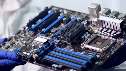 A young computer engineer holds and tests a processor Stock Footage 199465960