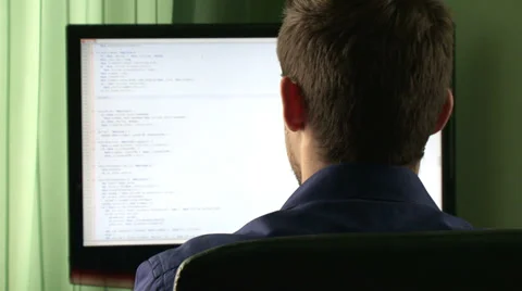 Young computer programmer at his desk Stock Footage 34510691