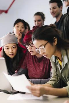 Young computer programmers working at laptop in meeting Stock-Fotos