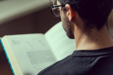 Young computer science student reads an advanced robotics book in Caceres, Spain Stock Photos
