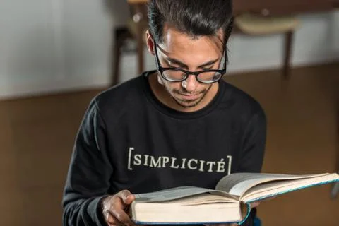 Young computer science student reads an advanced robotics book in Caceres, Spain Stock Photos