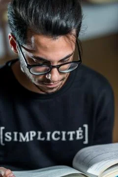Young computer science student reads an advanced robotics book in Caceres, Spain Stock Photos