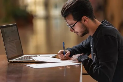 Young computer science student use a laptop to study in Caceres, Spain. Stock Photos