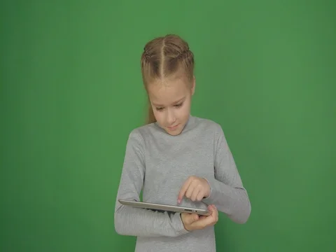 Young, conceived girl using touchscreen tablet technology and reading. Stock Footage 84728321