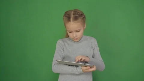 Young, conceived girl using touchscreen tablet technology and reading. Stock Footage 84729103